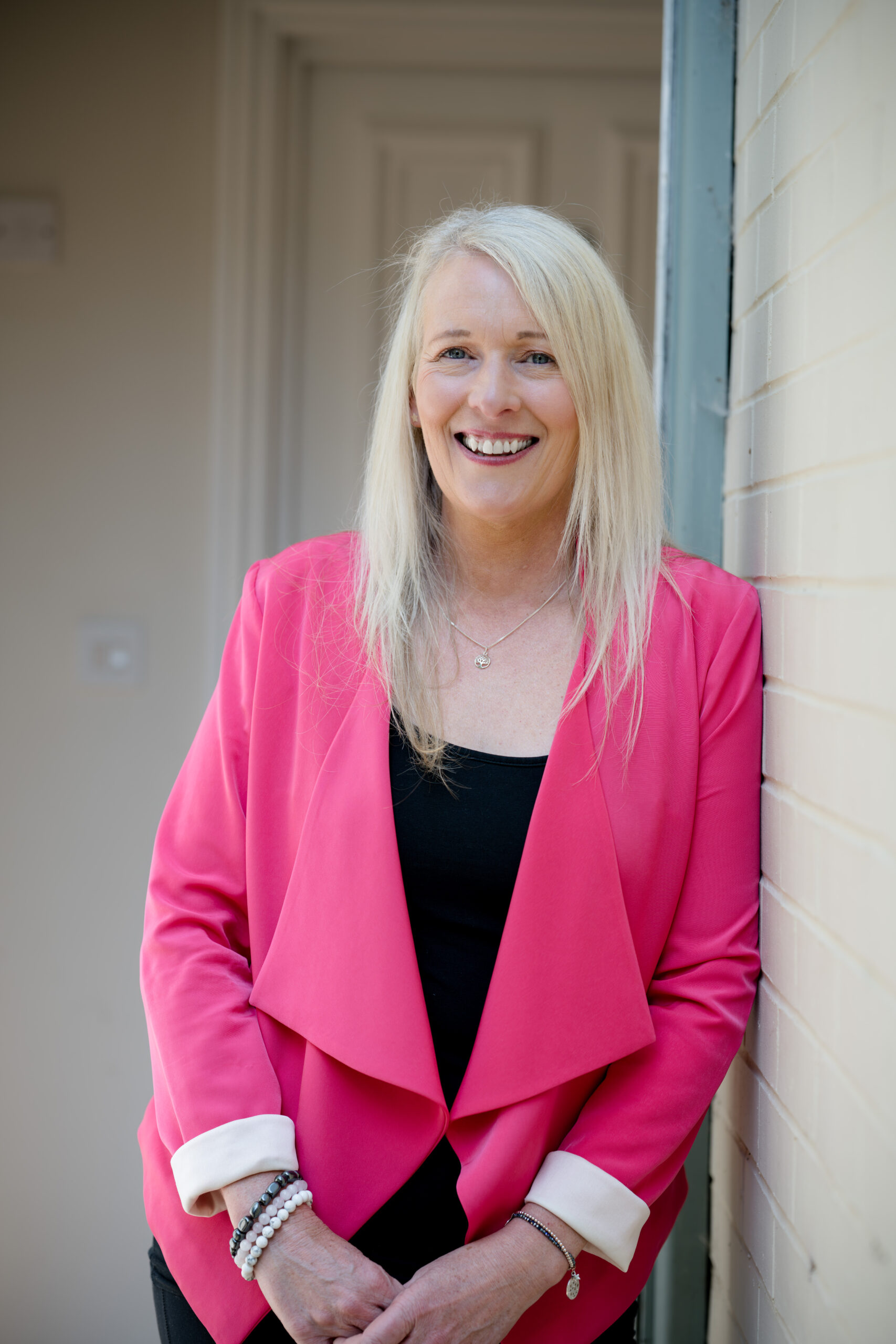 Headshot of female wearing pink jacket